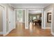 Welcoming foyer showcasing hardwood floors and open access to the dining room at 4435 Pemberton Cv, Johns Creek, GA 30022