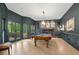 This game room features a billiard table, large windows with a view, and custom millwork at 4435 Pemberton Cv, Johns Creek, GA 30022