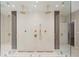 Modern glass enclosed shower features dual rainfall showerheads and sleek bronze hardware at 4435 Pemberton Cv, Johns Creek, GA 30022