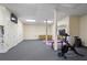 The gym features a stationary bike, a workout bench, yoga mats, storage closets, and a full-length mirror at 4435 Pemberton Cv, Johns Creek, GA 30022