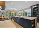 Open concept kitchen features a large island with counter seating, stainless appliances, and lots of natural light at 4435 Pemberton Cv, Johns Creek, GA 30022