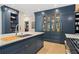 Modern kitchen offers custom cabinets, a large island with a sink, and stainless steel appliances for a luxurious culinary space at 4435 Pemberton Cv, Johns Creek, GA 30022