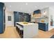 Bright kitchen features a large center island with seating, custom cabinets, and stainless steel appliances for a chef's delight at 4435 Pemberton Cv, Johns Creek, GA 30022