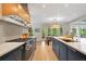Chef's kitchen boasts a professional-grade range, custom cabinets, and eat-in dining area overlooking the lush backyard at 4435 Pemberton Cv, Johns Creek, GA 30022