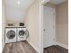 Modern laundry room with updated washer and dryer machines, new flooring and freshly painted walls at 4435 Pemberton Cv, Johns Creek, GA 30022