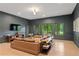 Spacious living room with hardwood floors, large windows, TV and comfortable seating at 4435 Pemberton Cv, Johns Creek, GA 30022
