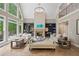 Comfortable living room with large windows, fireplace, and scenic outdoor views at 4435 Pemberton Cv, Johns Creek, GA 30022