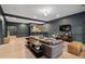 Large living room featuring hardwood floors, large windows, TV, bar and comfortable seating at 4435 Pemberton Cv, Johns Creek, GA 30022