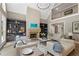 Inviting living room with cozy seating, built-in shelves, and a stone fireplace at 4435 Pemberton Cv, Johns Creek, GA 30022