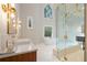 Luxurious main bathroom with a glass shower, soaking tub, and dual vanities with elegant lighting at 4435 Pemberton Cv, Johns Creek, GA 30022