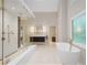Bright and modern main bathroom featuring a glass shower, soaking tub, and dual vanities at 4435 Pemberton Cv, Johns Creek, GA 30022