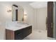 This elegant bathroom features a modern vanity with sleek black cabinets and bronze hardware at 4435 Pemberton Cv, Johns Creek, GA 30022