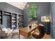 Stylish home office with custom built-in bookshelves, large windows, and comfortable seating at 4435 Pemberton Cv, Johns Creek, GA 30022