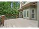 Outdoor patio features access to the home and a gorgeous backyard view with mature trees and railings at 4435 Pemberton Cv, Johns Creek, GA 30022