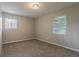 A bright bedroom with natural light from two windows and neutral carpet at 4748 Carson Sw Pass, Atlanta, GA 30331