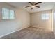A bedroom featuring two windows for natural light and neutral carpet at 4748 Carson Sw Pass, Atlanta, GA 30331