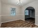 An empty dining room featuring dark wood floors and natural light from a window at 4748 Carson Sw Pass, Atlanta, GA 30331