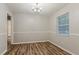Dining room with wood floors, chandelier lighting, chair railing, and window with natural light at 4748 Carson Sw Pass, Atlanta, GA 30331