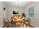 Stylish dining room featuring a wooden table, modern chairs, wood-look floors, and a contemporary light fixture at 4748 Carson Sw Pass, Atlanta, GA 30331
