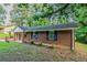 Side view of a classic brick ranch-style house, showcasing its clean lines, dark shutters and simple landscaping at 4748 Carson Sw Pass, Atlanta, GA 30331