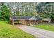A brick house, featuring a carport and a long driveway, nestled amidst a lush, green landscape at 4748 Carson Sw Pass, Atlanta, GA 30331