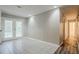 Hallway featuring tile flooring, doors to the backyard, neutral paint, and access to a bathroom at 4748 Carson Sw Pass, Atlanta, GA 30331