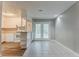Open kitchen with wood floors, white cabinets, adjacent dining area with doors to the back yard at 4748 Carson Sw Pass, Atlanta, GA 30331