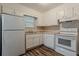 Functional kitchen with white cabinets, an oven/stove, dark hardware, and vinyl wood-look floors at 4748 Carson Sw Pass, Atlanta, GA 30331