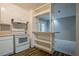 Bright kitchen with white cabinets, range, decorative backsplash, and breakfast bar to the living area at 4748 Carson Sw Pass, Atlanta, GA 30331