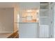 View of kitchen, including breakfast bar with shelving, connecting to another living space at 4748 Carson Sw Pass, Atlanta, GA 30331