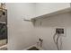A small laundry room features a shelf for storage and light wood look flooring at 4748 Carson Sw Pass, Atlanta, GA 30331