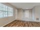 Inviting living room with tile and wood flooring, light grey paint, two entry doors, and natural light at 4748 Carson Sw Pass, Atlanta, GA 30331