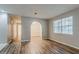 Spacious living room with wood flooring, light gray paint, arched doorway, and natural light at 4748 Carson Sw Pass, Atlanta, GA 30331