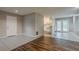 Open floor plan showcasing tile and wood flooring, neutral paint, and access to kitchen and backyard at 4748 Carson Sw Pass, Atlanta, GA 30331