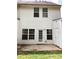 Exterior rear view of a house with a patio and a small storage shed at 301 Brookview Dr, Riverdale, GA 30274