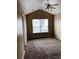 Cozy bedroom with a vaulted ceiling, neutral carpeting, and a bright window at 301 Brookview Dr, Riverdale, GA 30274