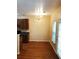 Open dining area with hardwood floors, a chandelier, and a door to the patio at 301 Brookview Dr, Riverdale, GA 30274