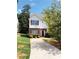 Charming two-story home features a brick and siding facade, complemented by well-maintained landscaping and a paved driveway at 301 Brookview Dr, Riverdale, GA 30274