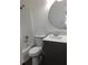 Bathroom featuring gray vanity with sink, mirror, toilet and shower with white tile at 3186 Kingswood Gln, Decatur, GA 30034