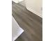 Close-up of wood look flooring with white baseboards and wall outlet at 3186 Kingswood Gln, Decatur, GA 30034