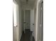 Bright hallway featuring hardwood floors and a linen closet for ample storage at 3186 Kingswood Gln, Decatur, GA 30034