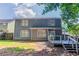 The backyard features a wooden deck, privacy fence, mature trees, and grass at 4968 Windsor Downs Ln, Decatur, GA 30035