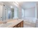 Bathroom featuring a double sink vanity, soaking tub, and tile accents at 4968 Windsor Downs Ln, Decatur, GA 30035
