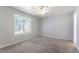 Comfortable bedroom with neutral carpet, ceiling fan, and a bright window at 4968 Windsor Downs Ln, Decatur, GA 30035