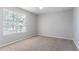 Bedroom with plush carpet and a large window at 4968 Windsor Downs Ln, Decatur, GA 30035