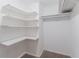 Walk-in closet with custom shelving provides ample storage space at 4968 Windsor Downs Ln, Decatur, GA 30035