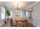 Inviting dining room with hardwood floors, a stylish chandelier, and French doors to the outside at 4968 Windsor Downs Ln, Decatur, GA 30035