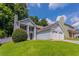 Captivating view of a home with a well-manicured lawn, chimney, and attached two-car garage at 4968 Windsor Downs Ln, Decatur, GA 30035