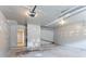 Unfinished garage with concrete floor and garage door openers waiting to be personalized at 4968 Windsor Downs Ln, Decatur, GA 30035