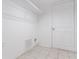 Tiled laundry room with shelving and a door at 4968 Windsor Downs Ln, Decatur, GA 30035